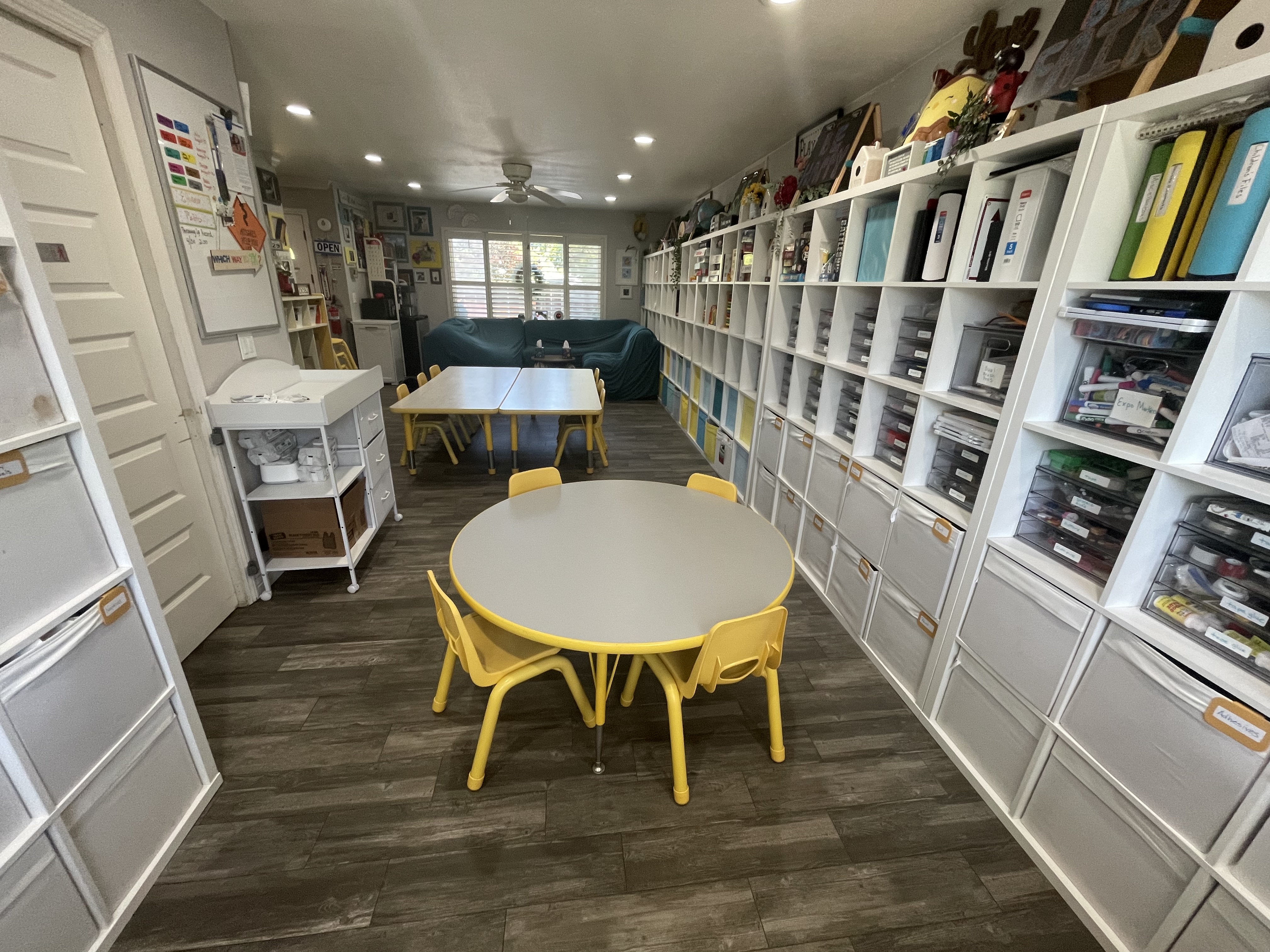 Mr. Ladybug Daycare classroom with yellow chairs and learning shelves